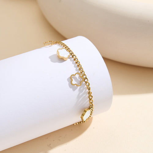 Aura Blossom gold lucky flower charm bracelet with natural white shell mother of pearl and open-work hollow geometric daisies in waterproof 304 stainless steel by LeeWey Luxury