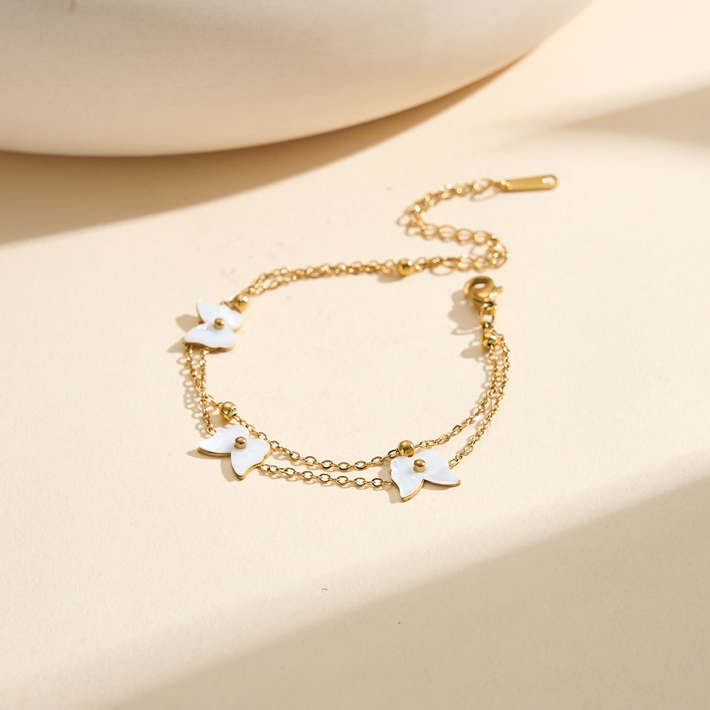 Aura Celestial gold lucky butterfly charm bracelet with natural white shell mother of pearl and polished metallic bead accents in waterproof 304 stainless steel by LeeWey Luxury