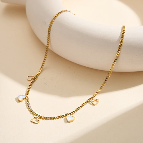 Aura Amour gold lucky heart charm necklace with natural white shell mother of pearl and open-work hollow geometric hearts in waterproof tarnish-free 304 stainless steel by LeeWey Luxury